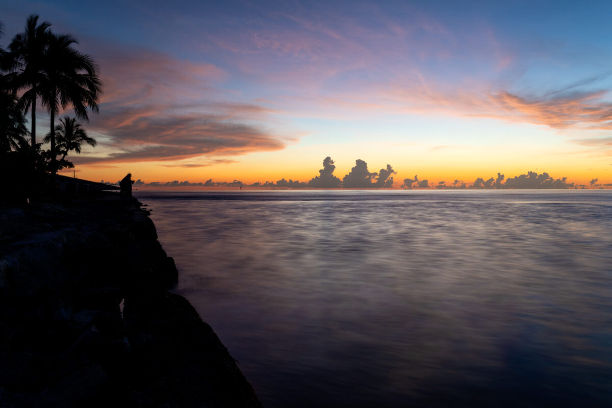 "Fishing in Marathon" fishermen enjoy the cooler air and sunset in Marathon Flordia. 